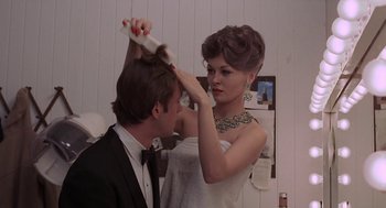 Movie still from “Puzzle of a Downfall Child” (1970), directed by Jerry Schatzberg – A man and a woman are combing each other's hair; Close Up shot, Over the shoulder angle