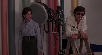 Movie still from “Puzzle of a Downfall Child” (1970), directed by Jerry Schatzberg – A man and a woman in front of a camera; Medium shot, Low angle