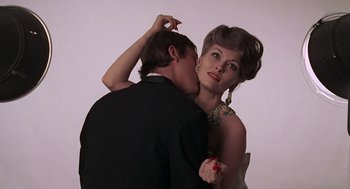 Movie still from “Puzzle of a Downfall Child” (1970), directed by Jerry Schatzberg – A man and a woman are kissing on the cheek; Close Up shot, Low angle