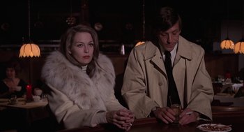 Movie still from “Puzzle of a Downfall Child” (1970), directed by Jerry Schatzberg – A man and a woman sitting at a table; Medium shot, Over the shoulder angle