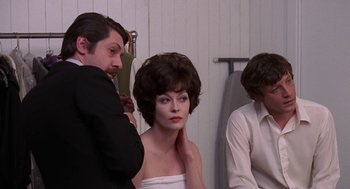 Movie still from “Puzzle of a Downfall Child” (1970), directed by Jerry Schatzberg – A woman with short brown hair is getting her hair done; Medium shot, Over the shoulder angle