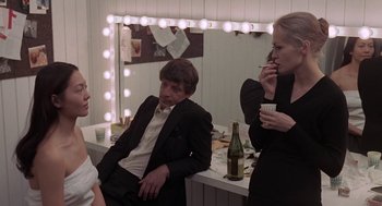 Movie still from “Puzzle of a Downfall Child” (1970), directed by Jerry Schatzberg – A man and two women in front of a vanity mirror; Medium shot, Over the shoulder angle