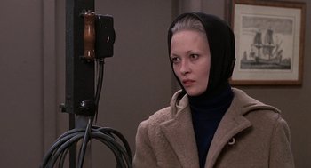 Movie still from “Puzzle of a Downfall Child” (1970), directed by Jerry Schatzberg – A woman wearing a hooded coat and a black scarf; Close Up shot, Over the shoulder angle