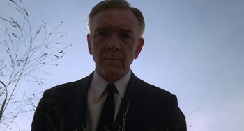 Movie still from “Puzzle of a Downfall Child” (1970), directed by Jerry Schatzberg – An older man wearing a suit and tie; Close Up shot, Low angle