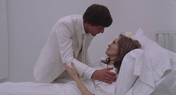 Movie still from “Puzzle of a Downfall Child” (1970), directed by Jerry Schatzberg – A man and a woman dressed in wedding attire; Medium shot, Overhead angle