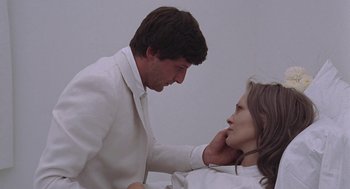 Movie still from “Puzzle of a Downfall Child” (1970), directed by Jerry Schatzberg – A man and a woman in a white suit; Close Up shot, Over the shoulder angle