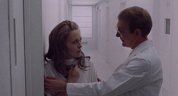 Movie still from “Puzzle of a Downfall Child” (1970), directed by Jerry Schatzberg – A woman in a white lab coat and a man in a white lab coat; Medium shot, Over the shoulder angle