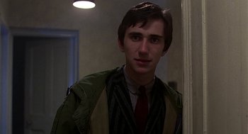 Movie still from “Quadrophenia” (1979), directed by Franc Roddam – A man in a green jacket and a red tie; Close Up shot, Over the shoulder angle