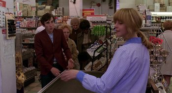 Movie still from “Quadrophenia” (1979), directed by Franc Roddam – A group of people standing in a store; Medium shot, Over the shoulder angle