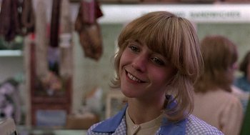 Movie still from “Quadrophenia” (1979), directed by Franc Roddam – A woman with blonde hair and a blue jacket; Close Up shot, Low angle