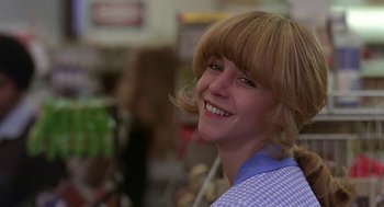 Movie still from “Quadrophenia” (1979), directed by Franc Roddam – A woman with blonde hair smiles for the camera; Close Up shot, Low angle