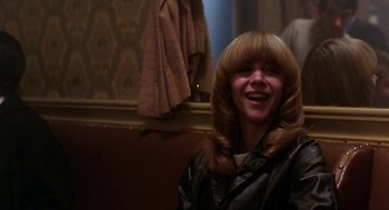 Movie still from “Quadrophenia” (1979), directed by Franc Roddam – A woman with blonde hair and bangs smiling; Close Up shot, Over the shoulder angle