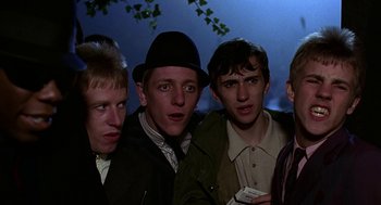 Movie still from “Quadrophenia” (1979), directed by Franc Roddam – A group of young men standing next to each other; Medium shot, Low angle