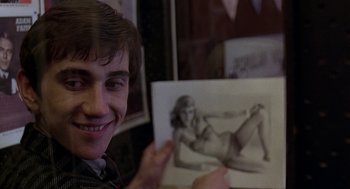 Movie still from “Quadrophenia” (1979), directed by Franc Roddam – A young man holding up a drawing of a woman; Close Up shot, Over the shoulder angle