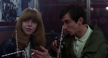 Movie still from “Quadrophenia” (1979), directed by Franc Roddam – A man and a woman sitting next to each other; Close Up shot, Low angle