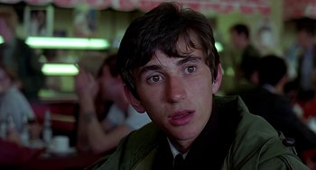 Movie still from “Quadrophenia” (1979), directed by Franc Roddam – A young man is looking into the camera; Close Up shot, Low angle