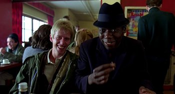 Movie still from “Quadrophenia” (1979), directed by Franc Roddam – A man in a hat and a man in a jacket and a hat; Medium shot, Low angle