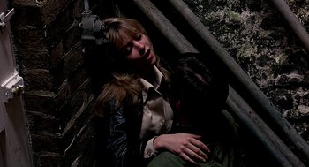 Movie still from “Quadrophenia” (1979), directed by Franc Roddam – A man and a woman hugging on the side of a building; Medium shot, Overhead angle