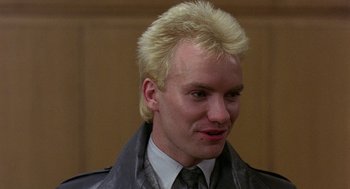 Movie still from “Quadrophenia” (1979), directed by Franc Roddam – A person wearing a suit and tie; Close Up shot, Low angle