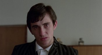 Movie still from “Quadrophenia” (1979), directed by Franc Roddam – A young man in a suit and tie looking at the camera; Close Up shot, Low angle