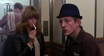 Movie still from “Quadrophenia” (1979), directed by Franc Roddam – A man and a woman sitting next to each other; Close Up shot, Over the shoulder angle