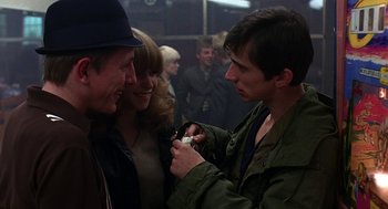 Movie still from “Quadrophenia” (1979), directed by Franc Roddam – A group of people standing next to each other in a room; Medium shot, Over the shoulder angle