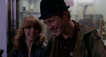 Movie still from “Quadrophenia” (1979), directed by Franc Roddam – A man and a woman smiling for the camera; Close Up shot, Low angle