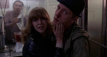 Movie still from “Quadrophenia” (1979), directed by Franc Roddam – A man and a woman standing next to each other; Close Up shot, Low angle