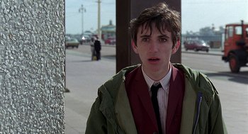 Movie still from “Quadrophenia” (1979), directed by Franc Roddam – A young man in a green jacket and a red jacket; Close Up shot, Over the shoulder angle