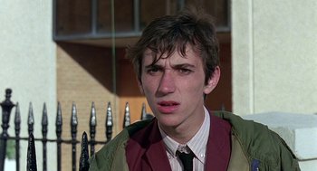 Movie still from “Quadrophenia” (1979), directed by Franc Roddam – A young man in a jacket and a tie; Close Up shot, Low angle