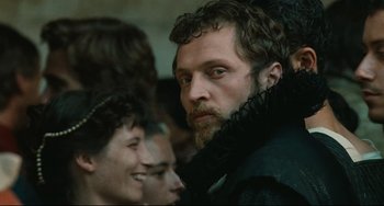 Movie still from “Queen Margot” (1994), directed by Patrice Chéreau – A person with a beard; Close Up shot, Over the shoulder angle