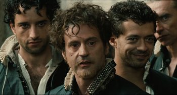 Movie still from “Queen Margot” (1994), directed by Patrice Chéreau – A group of men standing next to each other; Close Up shot, Over the shoulder angle