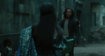 Movie still from “Queen Margot” (1994), directed by Patrice Chéreau – A man and a woman standing next to each other on a street; Medium shot, Over the shoulder angle