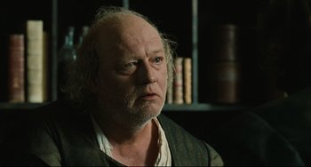 Movie still from “Queen Margot” (1994), directed by Patrice Chéreau – An older man with a beard and a mustache; Close Up shot, Over the shoulder angle