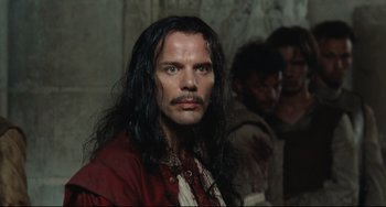 Movie still from “Queen Margot” (1994), directed by Patrice Chéreau – A person with long black hair; Close Up shot, Over the shoulder angle