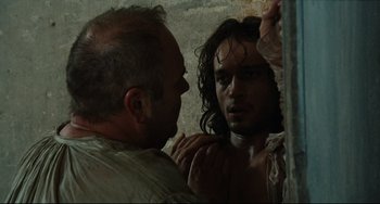 Movie still from “Queen Margot” (1994), directed by Patrice Chéreau – A man is looking at another man's face in the mirror; Close Up shot, Over the shoulder angle