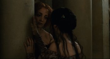 Movie still from “Queen Margot” (1994), directed by Patrice Chéreau – Two women standing next to each other in a dark room; Close Up shot, Over the shoulder angle