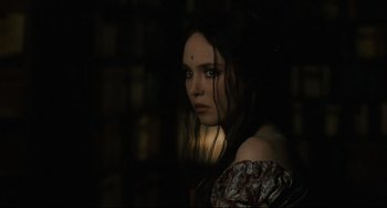 Movie still from “Queen Margot” (1994), directed by Patrice Chéreau – A woman in a dark room looking at the camera; Close Up shot, Over the shoulder angle