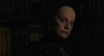 Movie still from “Queen Margot” (1994), directed by Patrice Chéreau – An older woman in a black dress looking at the camera; Close Up shot, Over the shoulder angle