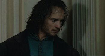 Movie still from “Queen Margot” (1994), directed by Patrice Chéreau – A person with long black hair; Close Up shot, Over the shoulder angle