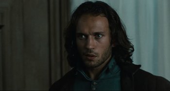 Movie still from “Queen Margot” (1994), directed by Patrice Chéreau – A person with long black hair; Close Up shot, Over the shoulder angle