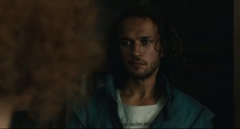 Movie still from “Queen Margot” (1994), directed by Patrice Chéreau – A man with long dark hair is staring at the camera; Close Up shot, Low angle