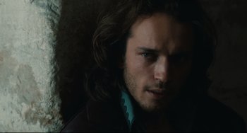 Movie still from “Queen Margot” (1994), directed by Patrice Chéreau – A person with long brown hair; Close Up shot, Over the shoulder angle