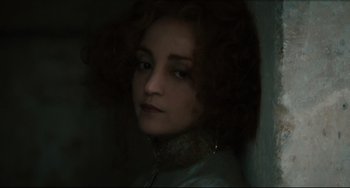 Movie still from “Queen Margot” (1994), directed by Patrice Chéreau – A woman with curly brown hair wearing a blue jacket; Close Up shot, Low angle