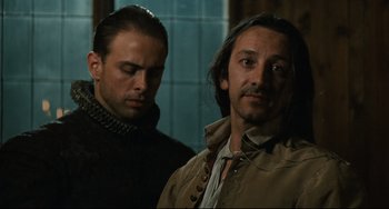 Movie still from “Queen Margot” (1994), directed by Patrice Chéreau – Two men standing next to each other in front of a window; Close Up shot, Over the shoulder angle