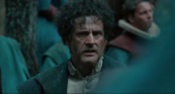 Movie still from “Queen Margot” (1994), directed by Patrice Chéreau – A person with a beard and curly hair; Close Up shot, Over the shoulder angle