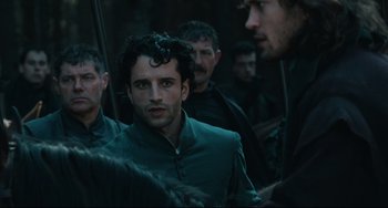 Movie still from “Queen Margot” (1994), directed by Patrice Chéreau – A group of men standing next to each other in a forest; Close Up shot, Over the shoulder angle