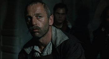 Movie still from “Queen Margot” (1994), directed by Patrice Chéreau – A man with a goatee is looking at the camera; Close Up shot, Low angle