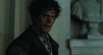 Movie still from “Queen Margot” (1994), directed by Patrice Chéreau – A person wearing a suit and tie; Close Up shot, Low angle