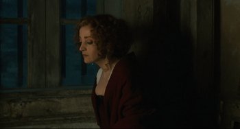Movie still from “Queen Margot” (1994), directed by Patrice Chéreau – A woman with curly red hair standing in front of a window; Medium shot, High angle
